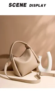 Macro detail of beige pebble grain leather bag texture with silver hardware hooks