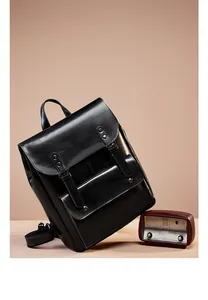 Detail of vintage black leather backpack with flap cover and buckle straps for women