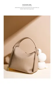 Detail of apricot pebbled leather Hobo bag with soft texture and wide top handle