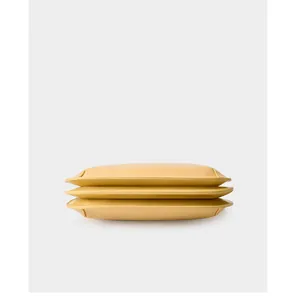 Detail view showing the three-layer accordion structure of the leather shoulder bag