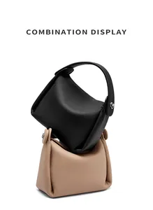 Close-up of litchi grain leather bucket bags in black and tan with silver buckle detail