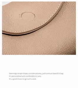 Close-up of pebble grain cowhide leather texture on a beige minimalist handbag