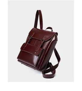 Side view of dark burgundy leather backpack showing its vintage structure and thickness