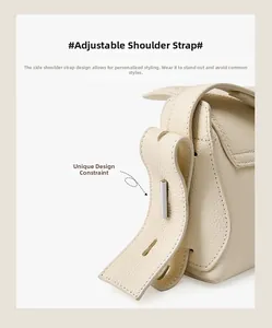 Détail de la bandoulière réglable avec boucle en métal argenté sur sac en cuir beige