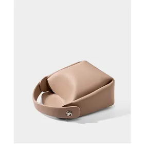 Macro detail of high-quality lychee grain leather handbag with silver metal buckle