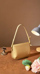 Exquisite compact light yellow leather underarm bag with slim strap and curved design
