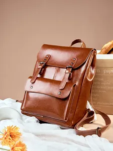 Retro brown leather backpack with front buckle pockets and vintage college aesthetic