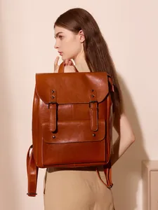 Vintage brown leather backpack with classic flap cover and buckle straps for women