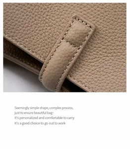 Macro shot of khaki pebble grain leather tote bag with precision stitching detail