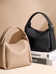 Minimalist lychee pattern cowhide leather bucket bag in classic black and beige tones