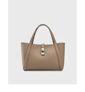 Detailed view of grey lychee grain leather tote with a silver metal twist lock closure