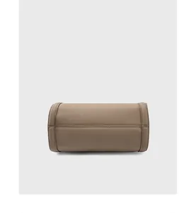 Detailed base view showing genuine brown lychee grain leather and fine stitching on the tote