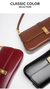 Close-up of leather shoulder bags in brown, wine red and black with gold metal clasps