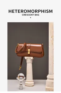 Detail of premium brown leather shoulder bag with gold clasp on a classic pedestal