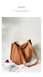 Detail of caramel leather tote with silver buckle and adjustable shoulder strap