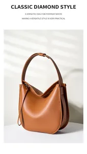 Detail view of brown leather hobo bag with wide side gusset and long leather zipper pull