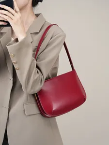 Minimalist deep red leather underarm shoulder bag with a vintage French style design