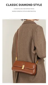 Detail view of a vintage brown leather baguette bag with a gold rectangular metal swivel lock