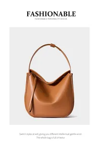 Detailed macro view of the premium brown leather texture and stitching on the tote bag
