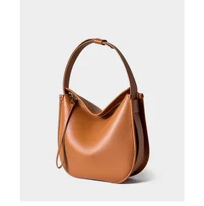 Detailed side view of the caramel brown leather tote bag with seamless wide shoulder strap