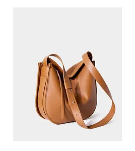 Detailed view of the brown leather hobo bag showing adjustable strap and side stitching