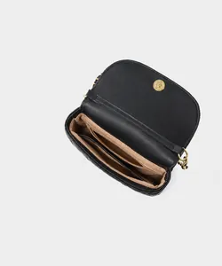 Detail view of leather bag interior showing main pocket, zipper bag, and inner pocket