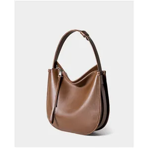 Detail shot of brown leather hobo bag side showing smooth zipper and premium texture