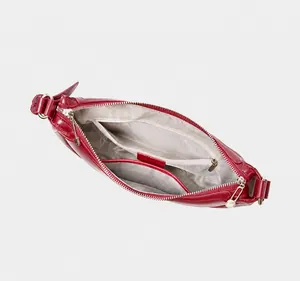 Interior layout of the crescent bag showing main pocket, zip pocket and phone compartment