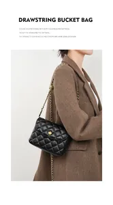 Detail of black quilted sheepskin bag with golden flower buckle and chain strap