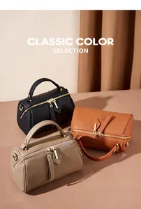 Three leather Boston bags in black, caramel, and khaki with golden metal hardware