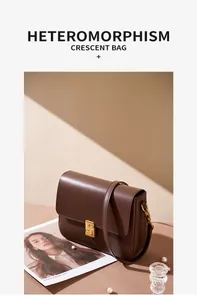 Detailed close-up of dark brown leather handbag featuring a gold S-shaped metal buckle