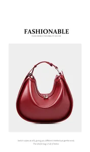 Detail of deep red crescent hobo bag showing matte leather texture and metal buckle