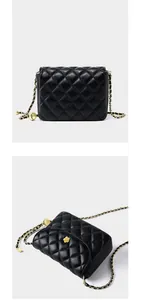Macro detail of black quilted leather bag with gold floral clasp and chain strap