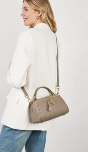 Taupe pebbled leather Boston bag worn as a shoulder bag with white blazer outfit