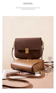 Close-up of minimalist leather crossbody bags in chocolate and camel with gold buckles