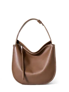 Minimalist brown leather hobo shoulder bag with smooth texture and long zipper puller