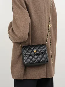 Classic black quilted leather crossbody bag with golden flower lock and chain strap