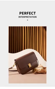 Close-up of a brown leather shoulder bag featuring an elegant square gold metal buckle