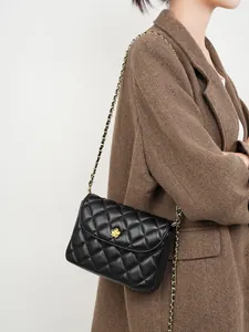 Elegant black quilted leather shoulder bag with gold floral clasp and chain strap