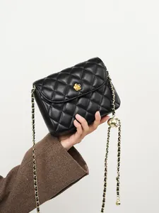 Quilted leather chain bag in black with gold floral hardware and adjustable strap