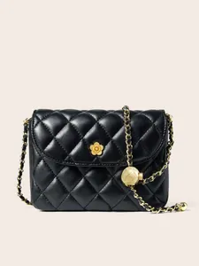 Black quilted leather shoulder bag with gold camellia clasp and adjustable ball chain