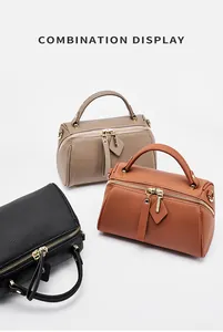 Boston bags in black, caramel, and taupe leather with gold zippers and top handles