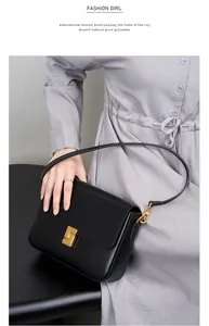 Detail of premium black leather shoulder bag showing the gold geometric metal clasp lock