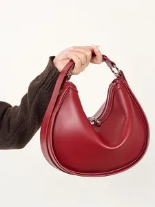 Minimalist burgundy crescent shoulder bag in premium matte leather with silver hardware