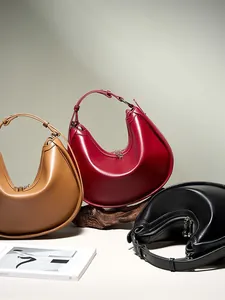 Minimalist crescent shoulder bags in burgundy, tan, and black smooth leather