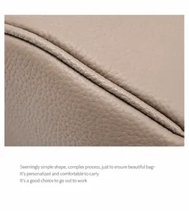 Close-up of litchi texture on genuine leather Boston bag with fine double stitching