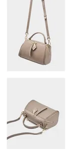 Close-up of litchi grain cowhide Boston bag with dual zippers and gold hardware