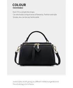 Detail shot of black Boston bag featuring premium lychee texture leather and gold hardware