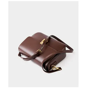 Top view of smooth brown leather crossbody bag with golden clasp and adjustable strap