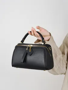 Classic black Boston bag in pebbled genuine leather with golden dual zippers and top handle